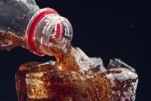 serving cola from bottle glass full ice